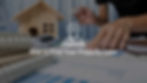 Photograph of hands drawing on a map with a wooden model of a home in the background and text overlay "How to Find Your Property Lines"
