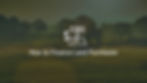 Photograph of farmland with a fence and trees in the background with fog