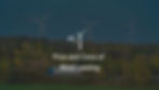 photograph of three wind turbines with yellow trees in the foreground