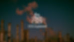 photograph of tall factories emitting steam into the sky