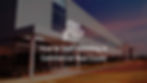 Photograph of a commercial building and a parking lot with text overlaid "How to Start Investing in CRE"