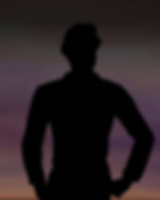 Landman standing outside in front of a sunset